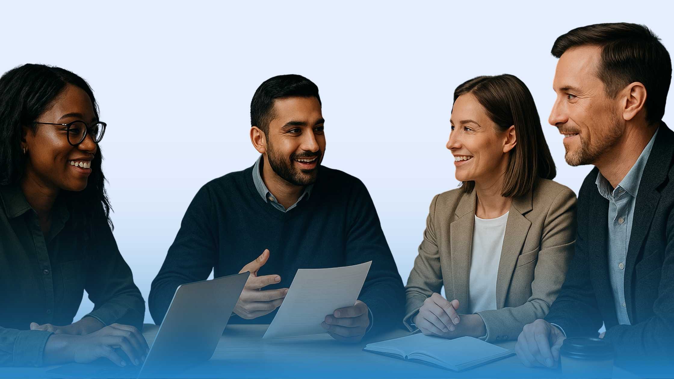 Four enterprise professionals collaborating in an office, reviewing contracts on a screen, representing AI for contract analysis in enterprises.