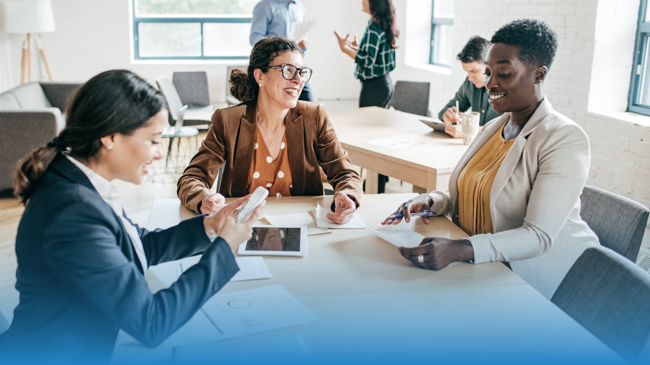 Team using AI for legal documents to analyze contracts, collaborate on insights, and benchmark terms in a modern office setting.