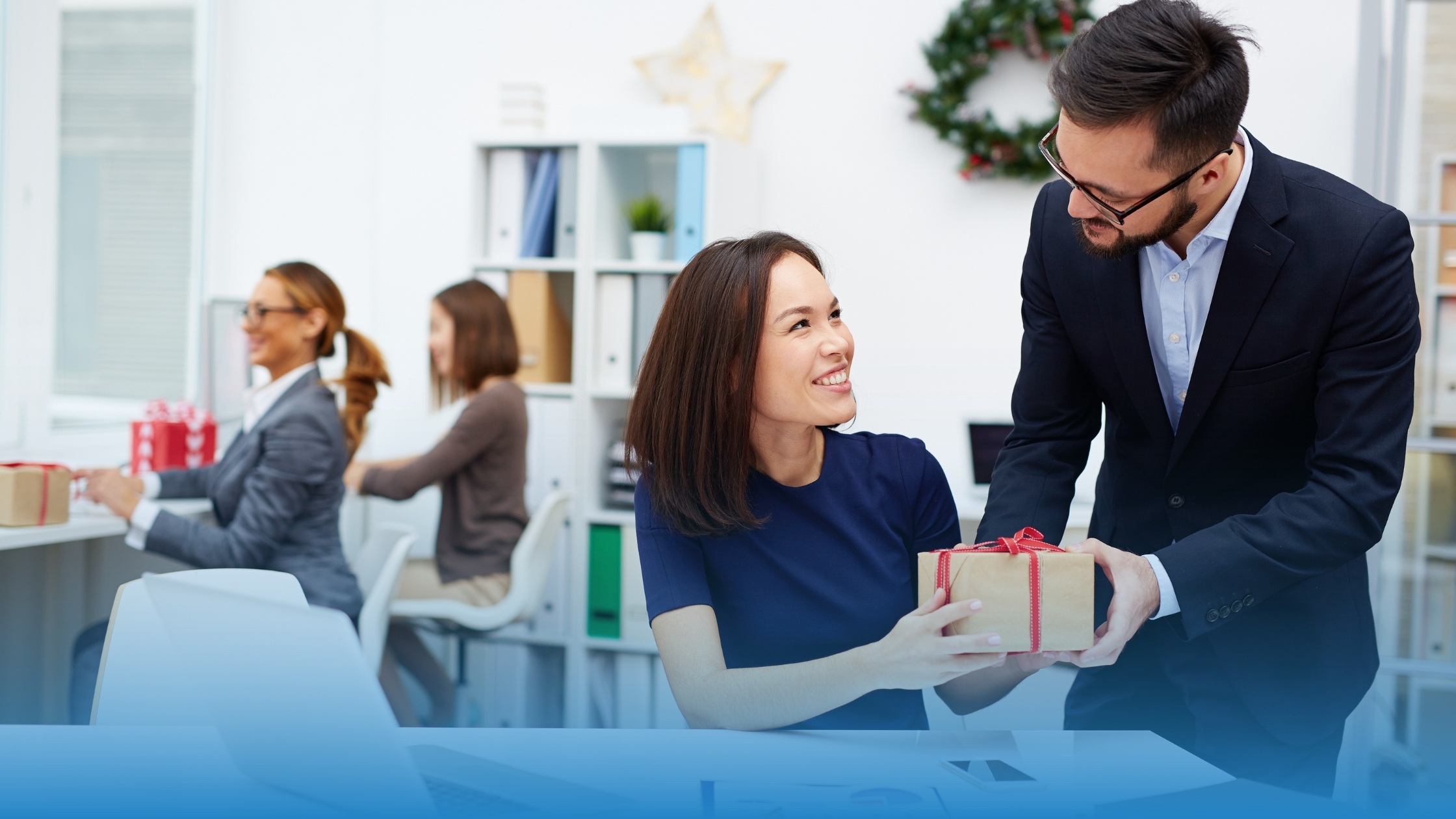 Business Person giving a gift to represent certified trust and transparency offered to customers in December.