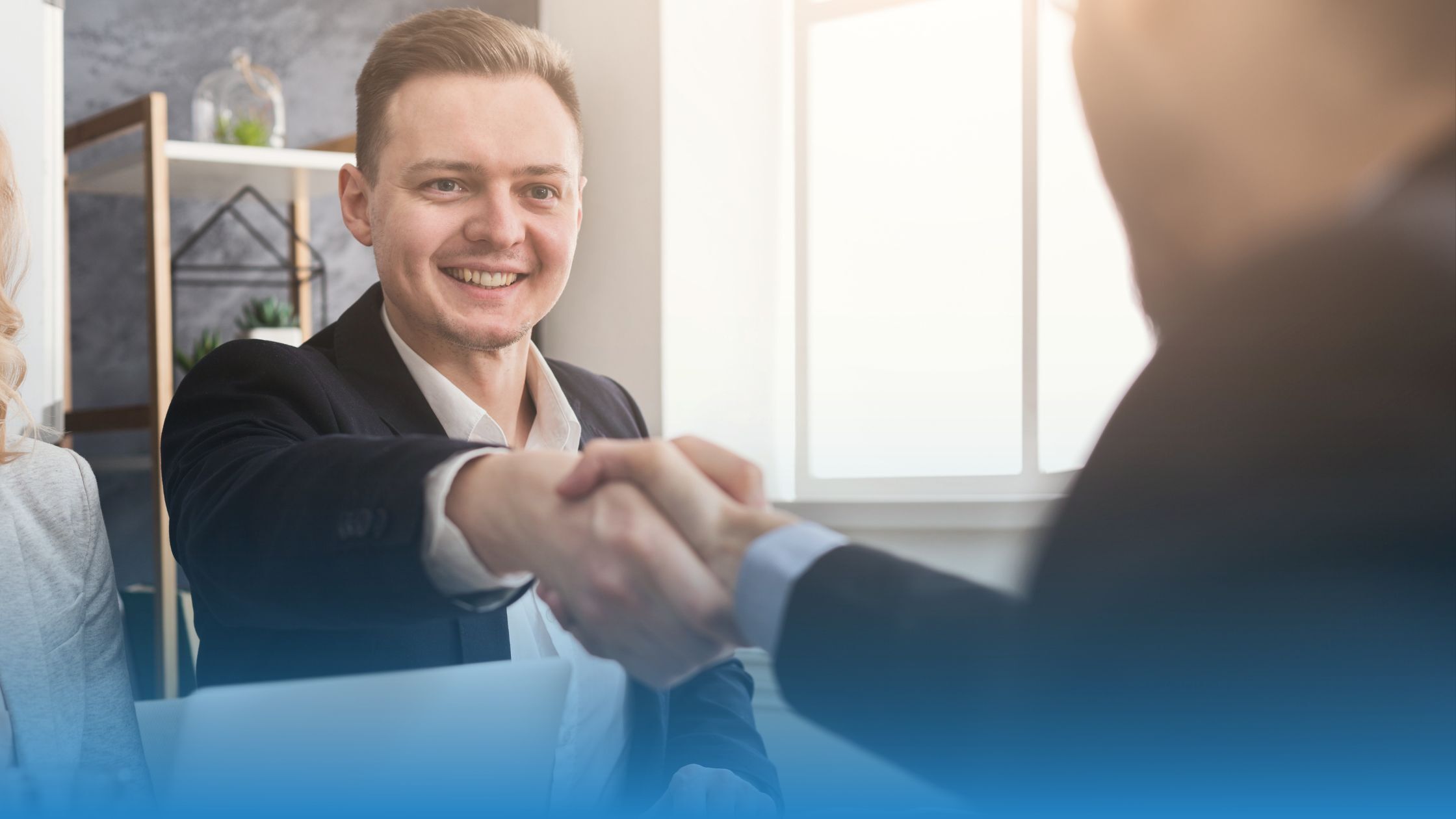 Two business professionals shaking hands to represent trust and agreement in modern contracting.