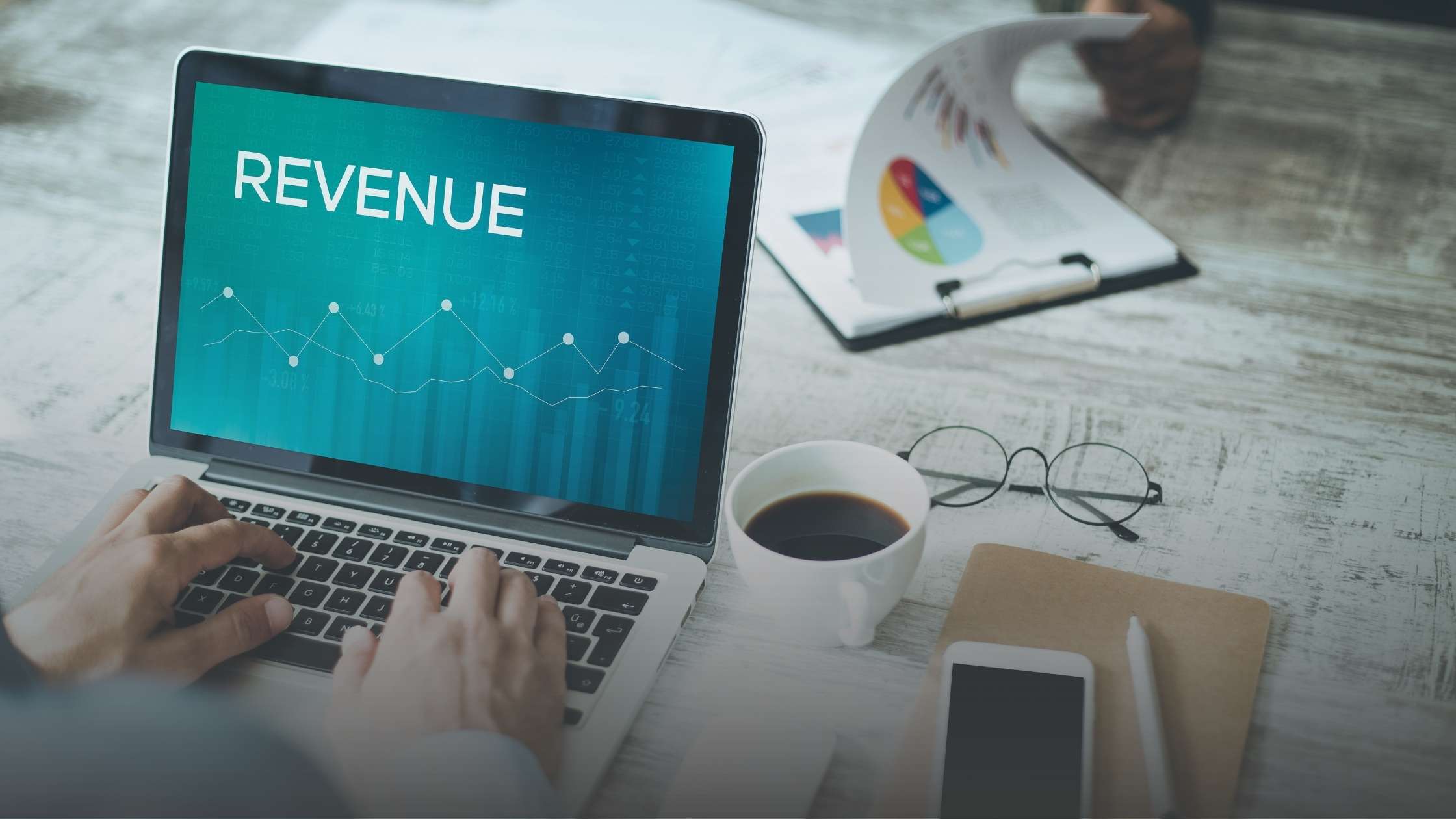 Finance professional analyzing revenue growth data on a laptop, illustrating how smarter contracts accelerate revenue and improve forecasting.