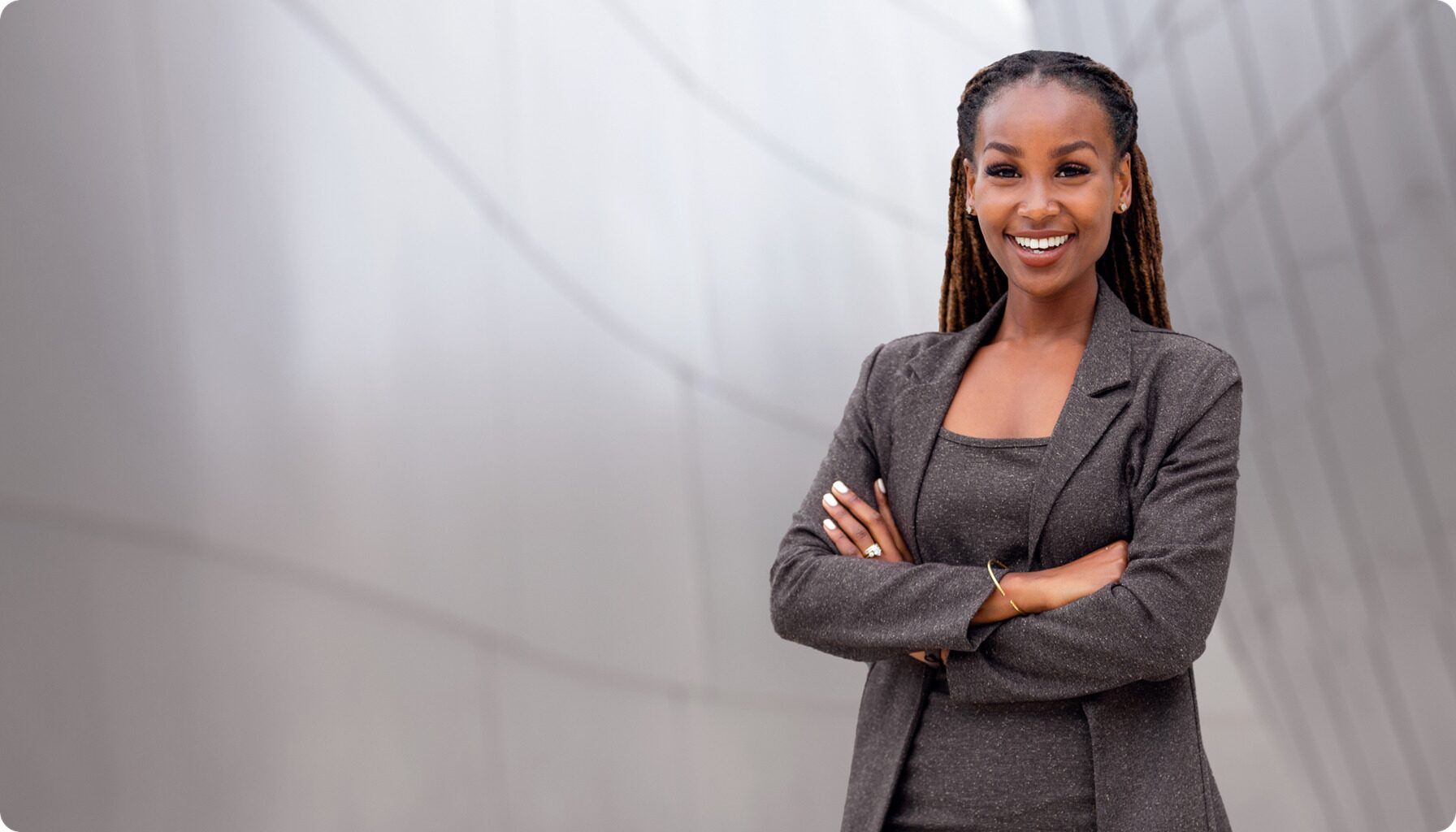 Confident businesswoman representing trust and professionalism in certified contracts, standing against a modern business backdrop.