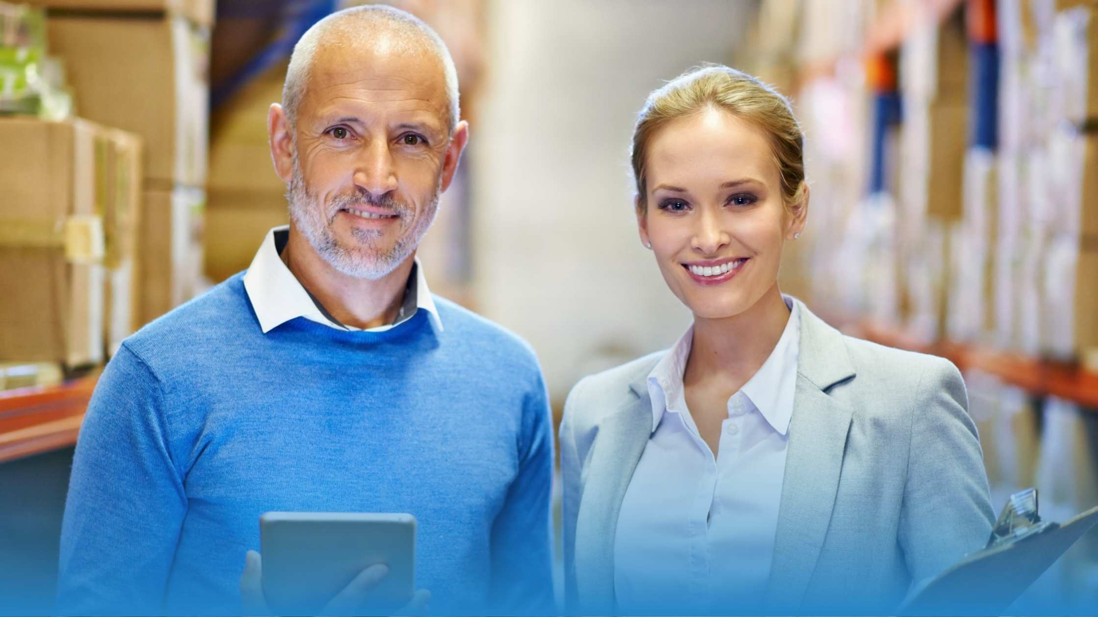 A couple of procurement professionals together smiling while talking about how to benchmark procurement contracts