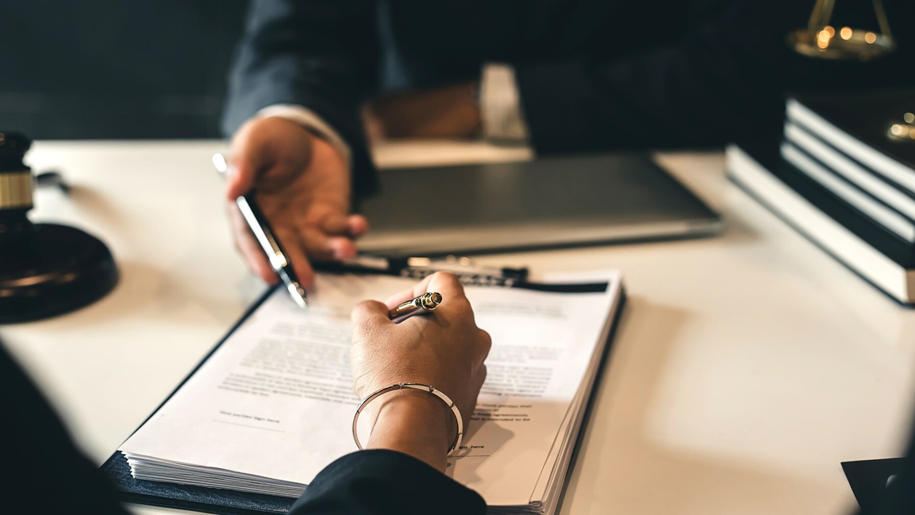 Two people discussing about contract terms | What’s Market in Customer Indemnification? |