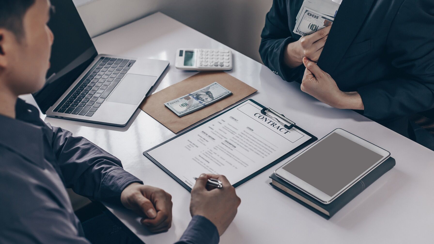 Business negotiation scene with a visible contract, cash on the table, and one person discreetly hiding money in a jacket