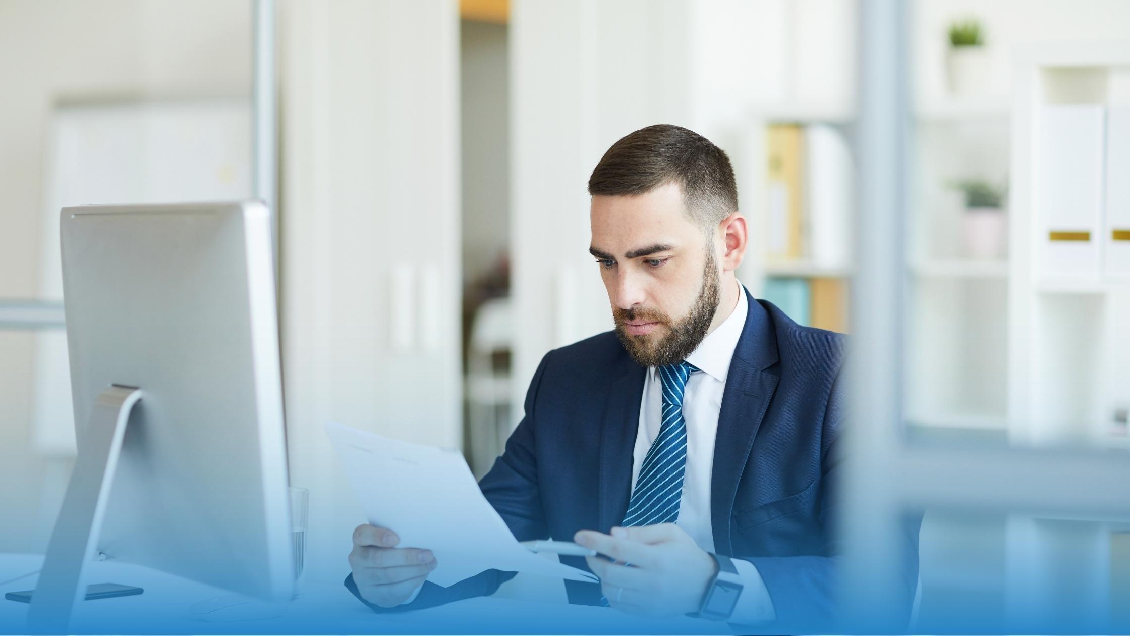 Why are contracts so hard to read: A professional struging to read contract terms in his office